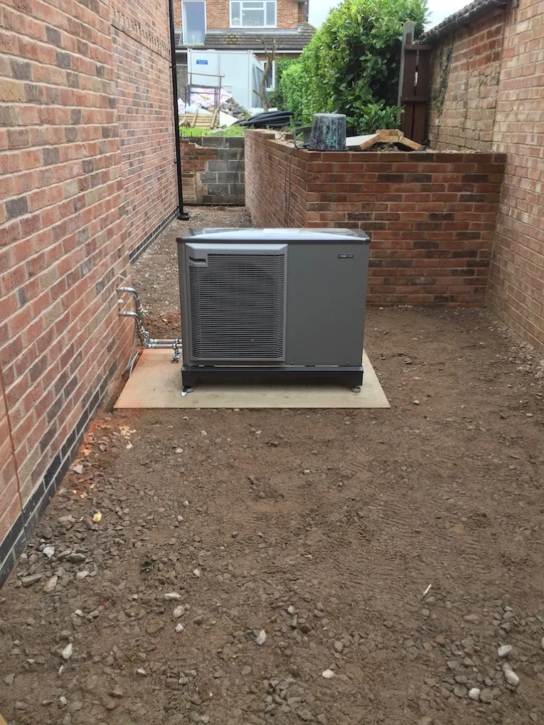 Air source heat pump outdoor unit installed in a side passage